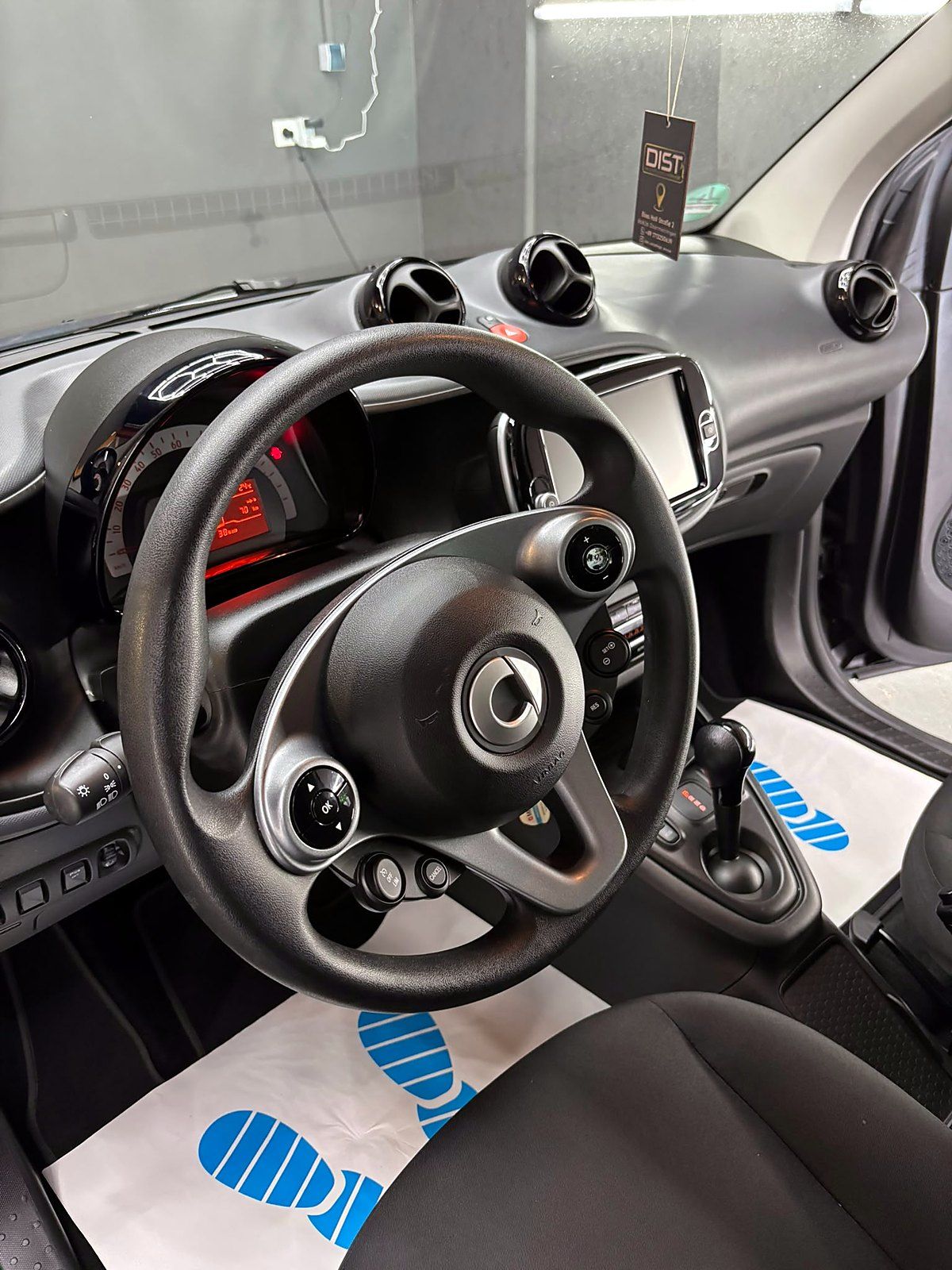 Gereinigtes Cockpit eines smart fortwo mit DIST-Duftanhänger am Rückspiegel